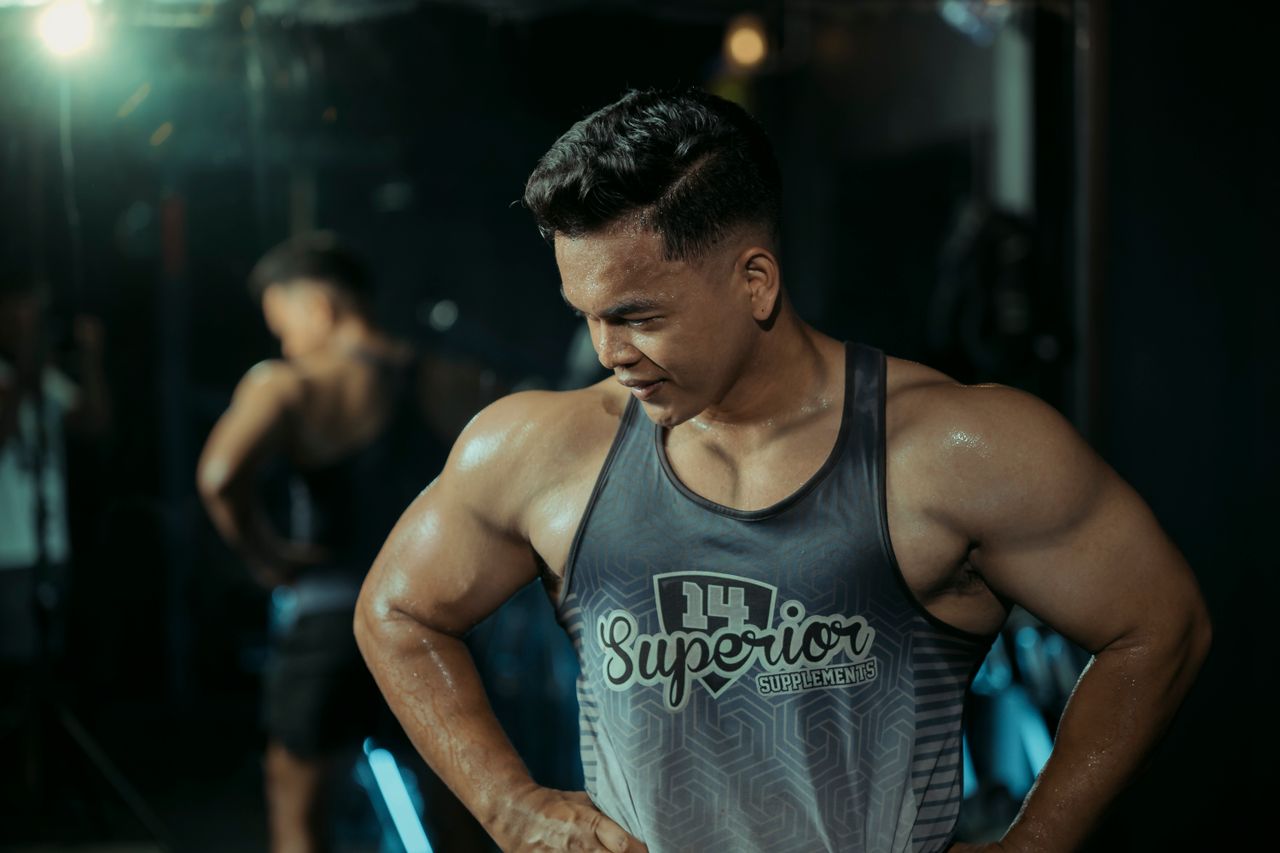 Muscular man in gym showing strength and determination.